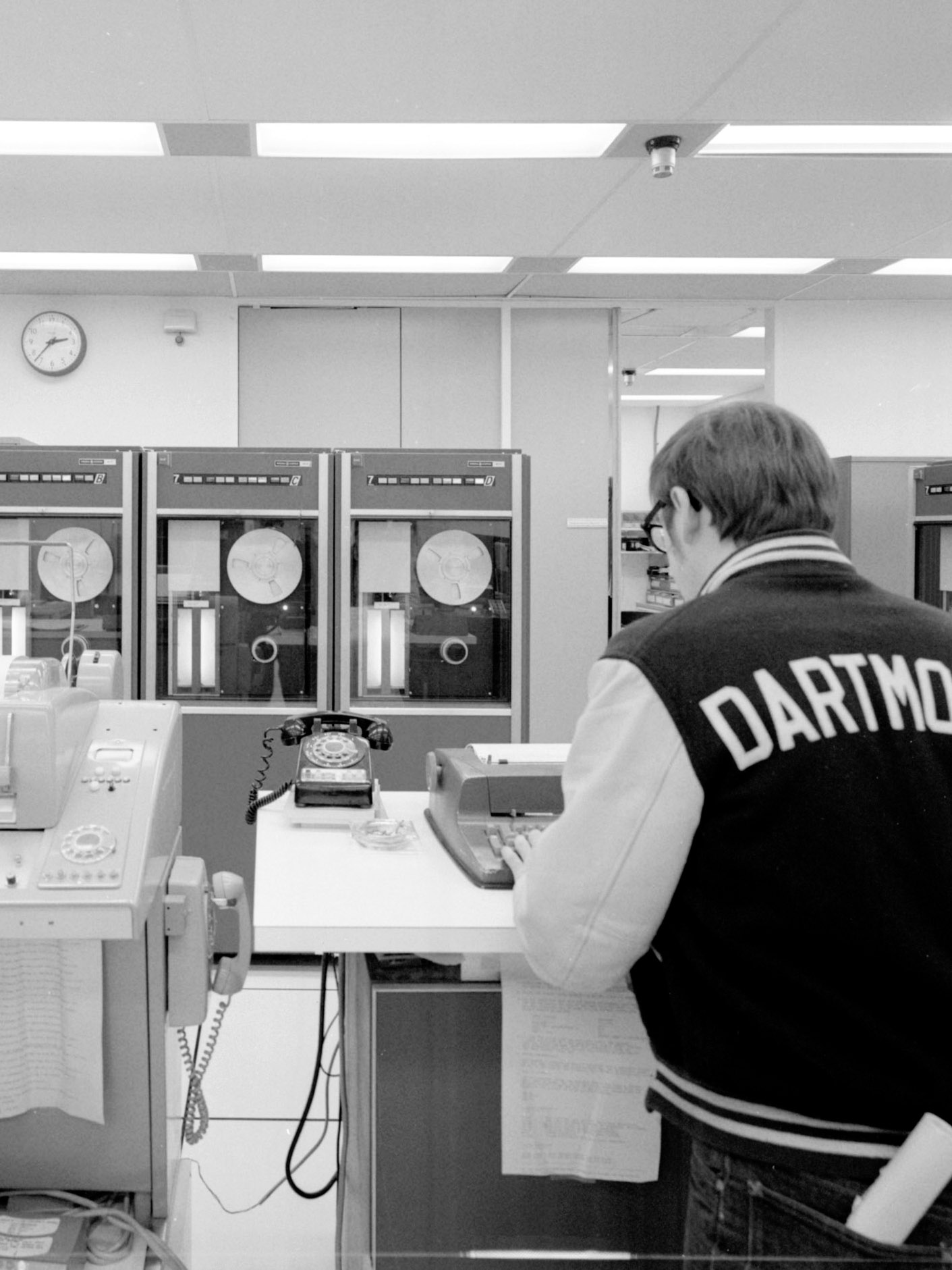 A student wearing a Dartmouth jacket works in the computation center